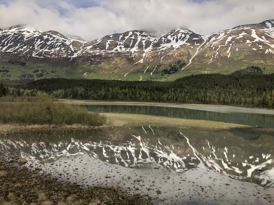 Snowy Chugach Mountains reflecting on the waters of the Gulf of Alaska.