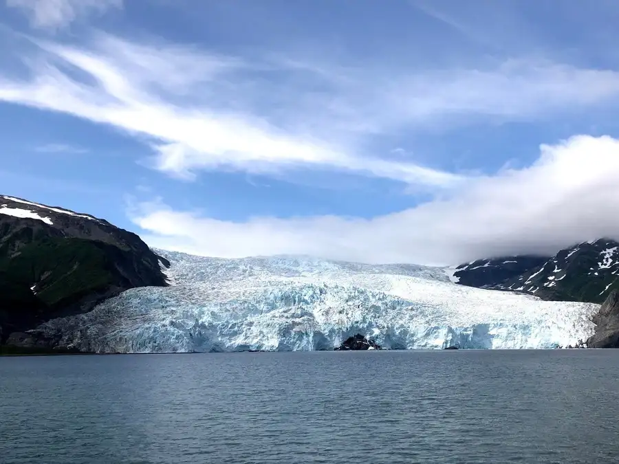 View across the waters of Alaska's Kenai Fjords to the glacier.
