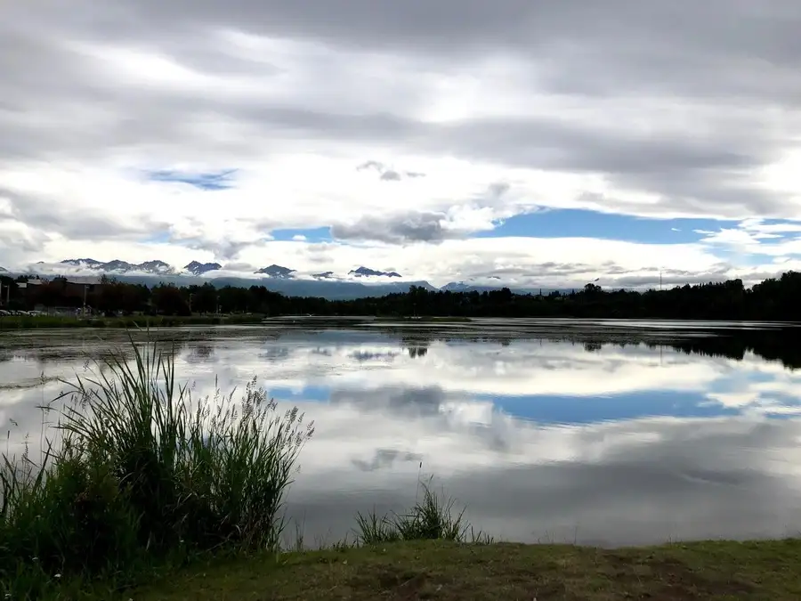 Clouds reflecting on Westchester Lagoon in Alaska.