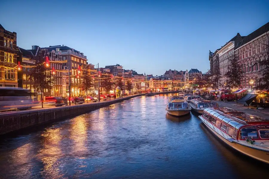 Amsterdam canal at dusk with December lights.