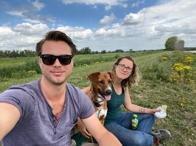 Christine Poile with her boyfriend and dog in a field.