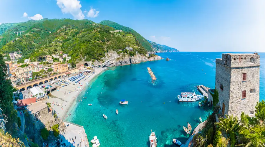 View over the watchtower to Monterosso beach and boats in the bay.