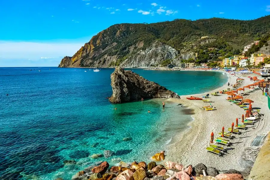 Monterosso beach with sun umbrellas and loungers by the Ligurian sea.