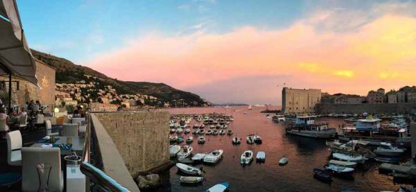 Restaurant terrace overlooking Adriatic Sea at sunset at Dubrovnik in Croatia.