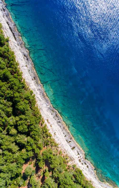 Green trees, white beach and turquoise sea at Pula is a beautiful place to visit in Croatia.
