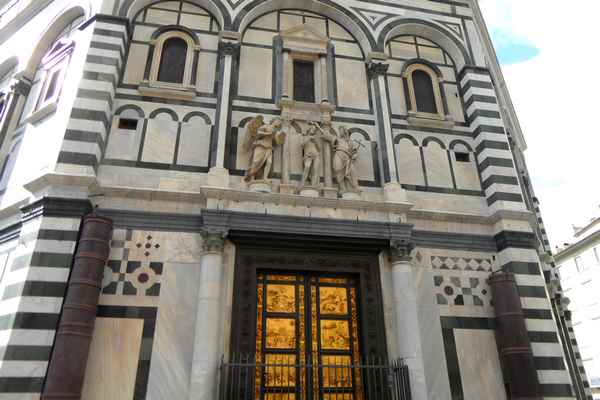 Bronze 'Gateway to Heaven' doors on marble façade of Florence Baptistery.