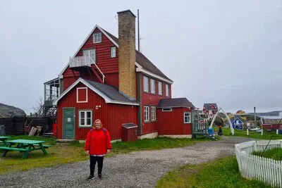 Julie Nielsen in front of her great-grandfather's home, the Govenor's House in Sismiut, Greenland. 