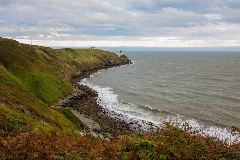 Grassy cliffs sloping down to the sea at Howth Head near Dublin.