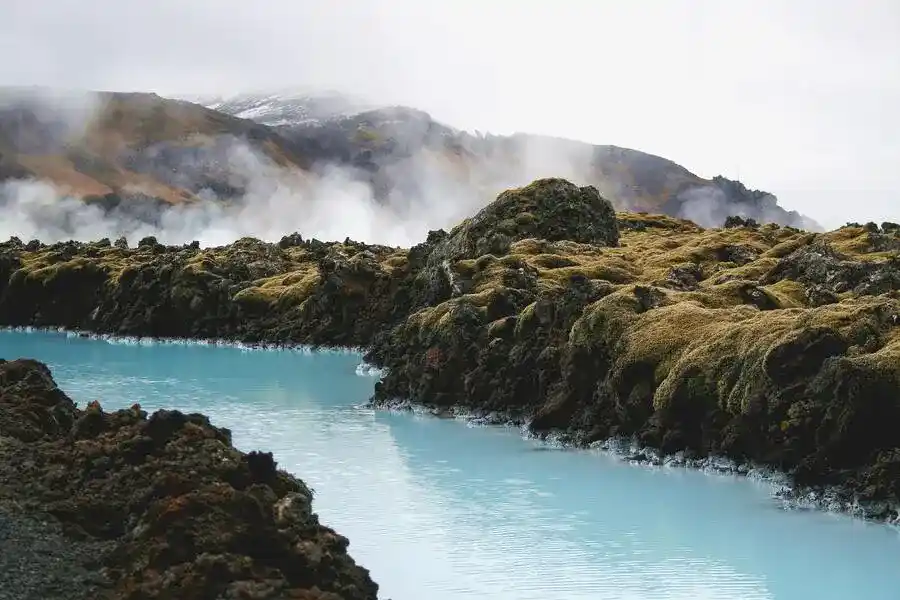 Iceland's Blue Lagoon flows between volcanic rock.