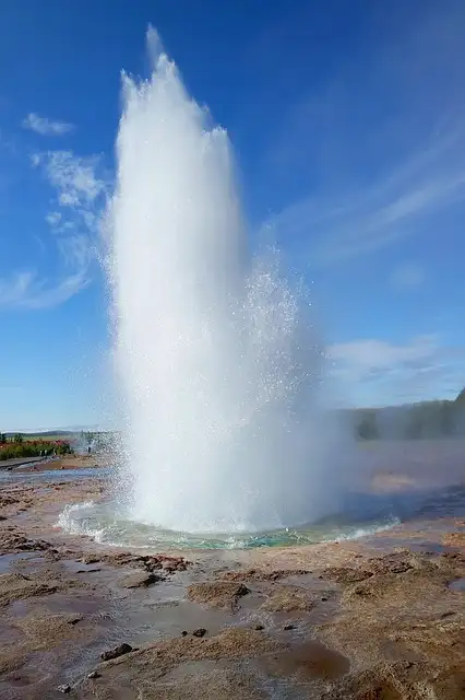 Strokkur geyser spewing boiling water to a great height.