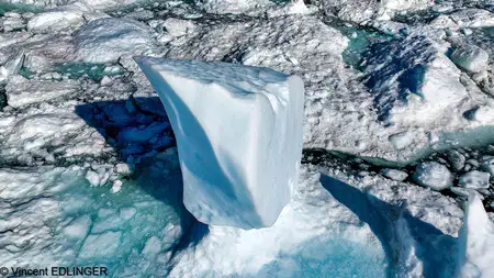 An iceberg calving a huge chunk of ice on Ilulissat Icecap.
