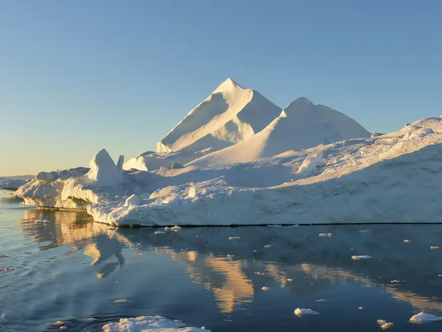 The midnight sun reflects off of the icebergs in the Ilulissat ice field.  