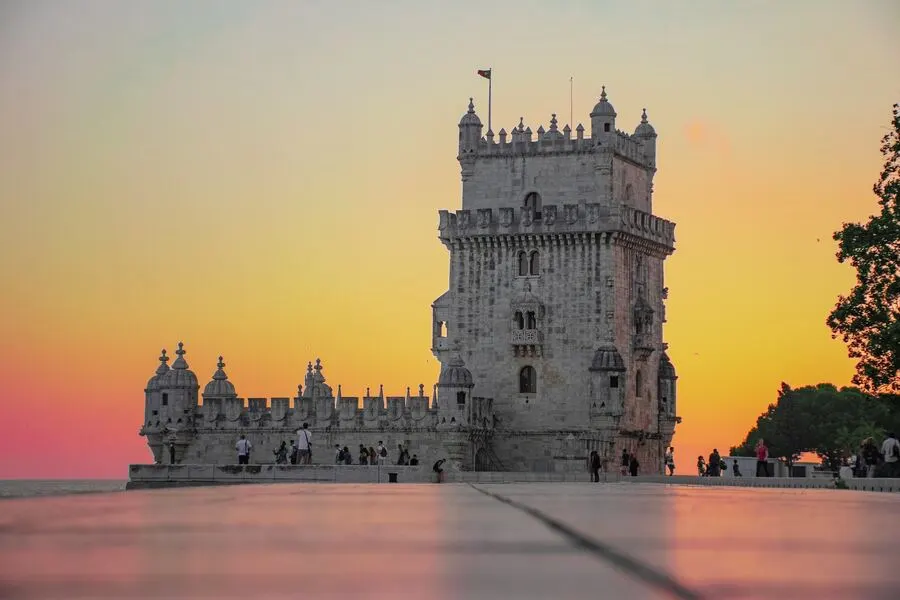 Belem's white gothic-style square tower at sunset.
