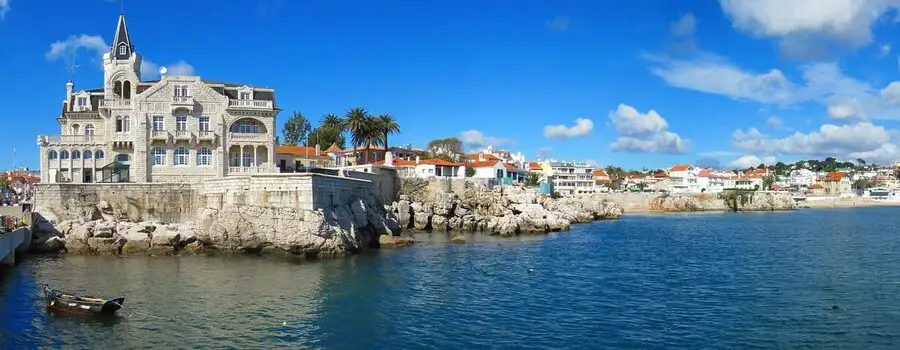 Cascais bay with mansions on the rocky seafront.