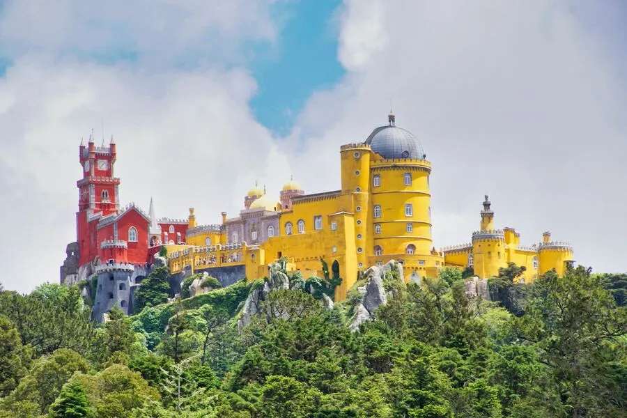 Sintra Pena palace with ornate red and yellow towers.