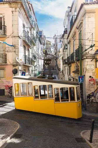 Lisbon's yellow funicular looks like a tram on the steep narrow streets.