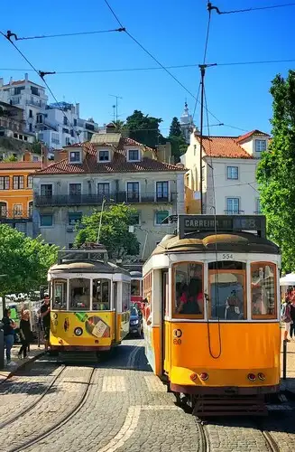Lisbon's yellow tram 28 going uphill.