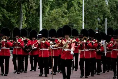 Queen's Guards military band marching by St James' Park.