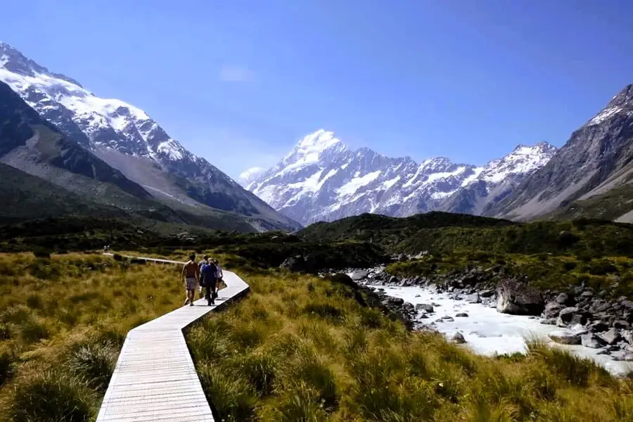 Board walk hike with snow-topped Mount Cook in the distance.