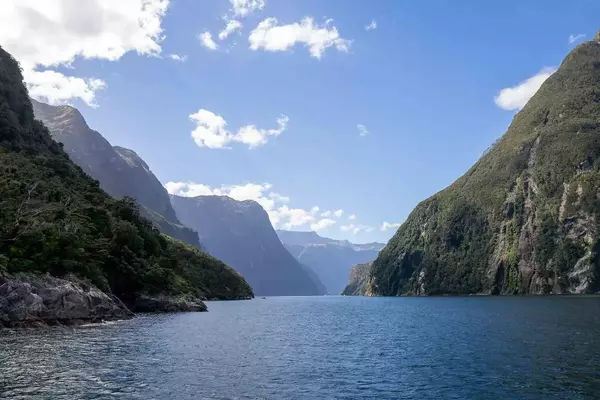 Waterway enclosed by high-walled fjord.