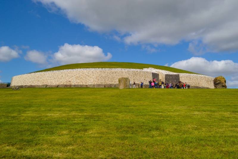 Grass slope up to Newgrange ancient burial chamber mound in Ireland.