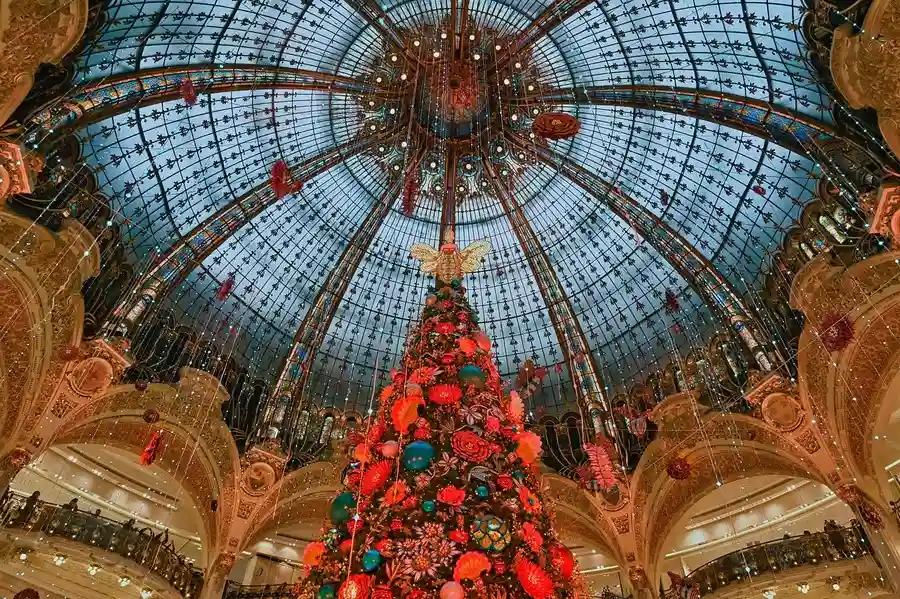 Red christmas tree under the dome in Galeries Lafayette in December. 