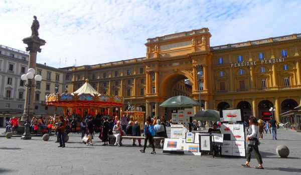 Florence's monumental Piazza della Repubblica with art stalls & a merry-go-round.