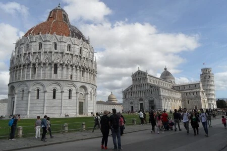 Pisa bapistery's huge dome with the cathedral and leaning tower behind.
