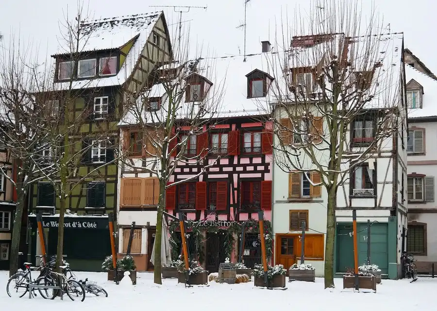 December snow-scene of half-timbered houses in Strasbourg old town.