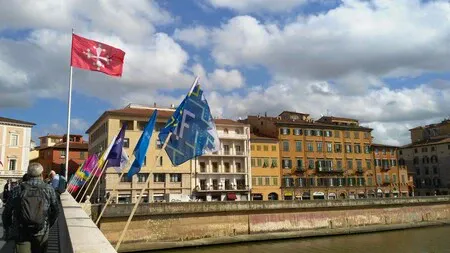 Flags on the Ponte di Mezzo bridge over the river.