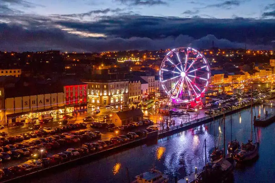 Ferris wheel and lights of Waterford Winterval by the river.